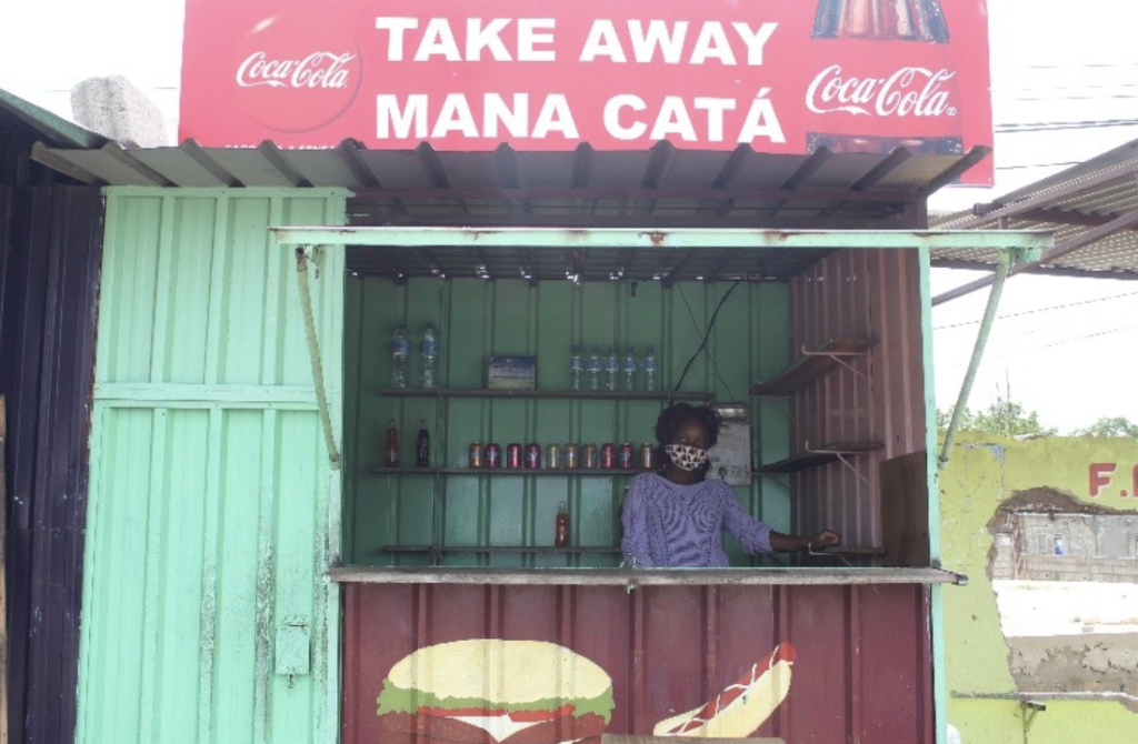 Catarina Bié stands inside her small takeout shop in Maputo, Mozambique. Part of TechnoServe's Photo of the Month series. 